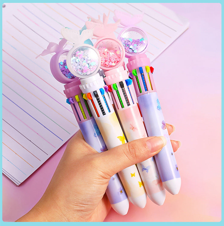 Multicolor ballpoint pen laid on test paper