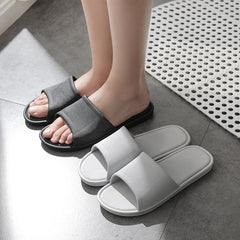 Couple's matching grey slippers displayed