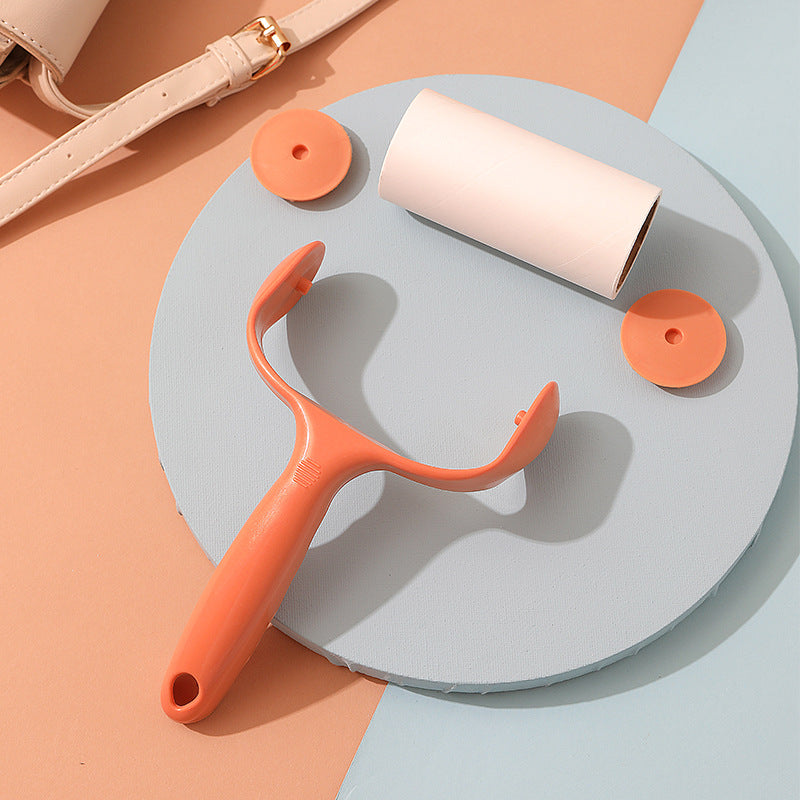 green lint roller in use on fabric