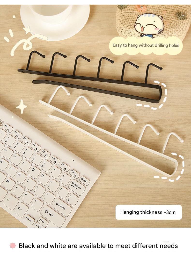 Over-the-door hook rack in black hanging on a door