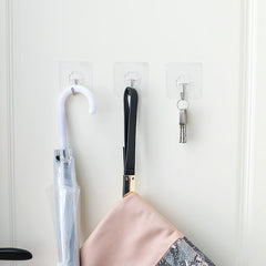 clear wall hook holding bathroom towel