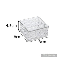 Clear storage box displaying makeup items