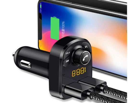 car charger beside manual on white