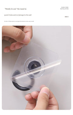 black adhesive hook mounted on textured wall