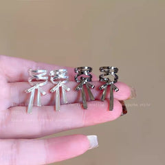 Elegant cross-style ear cuff in fashionable setting