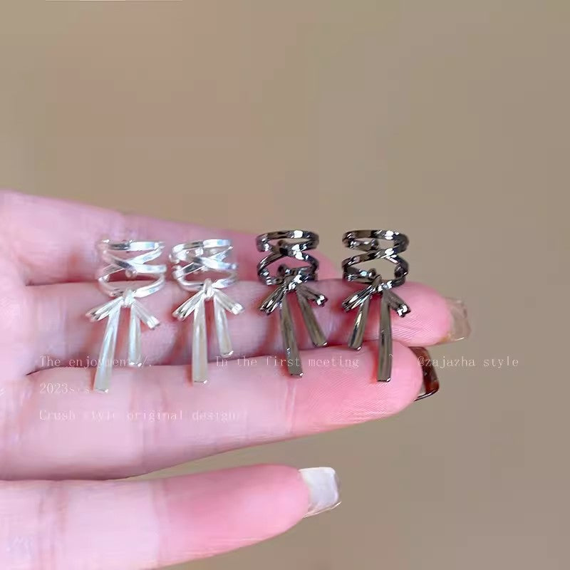 Elegant cross-style ear cuff in fashionable setting