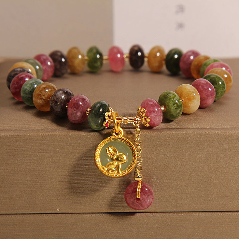 Natural colour tourmaline bracelet on white background