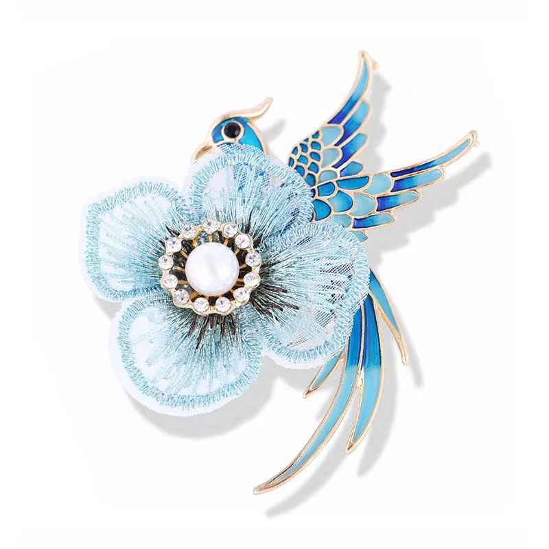 Handmade floral brooch displayed on fabric