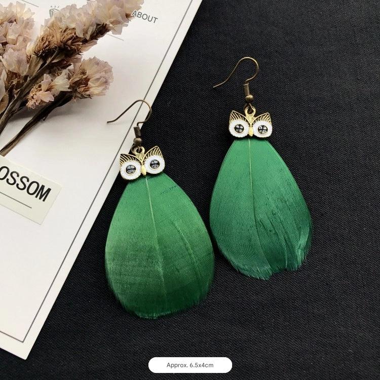 Peacock feather earrings on model image 5