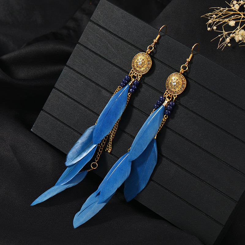 Closeup of stylish blue tassel earrings