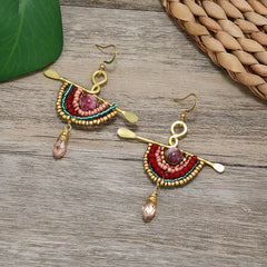 Artistic shot of unique woven tassel earrings