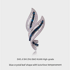 leaf design brooch securing a scarf