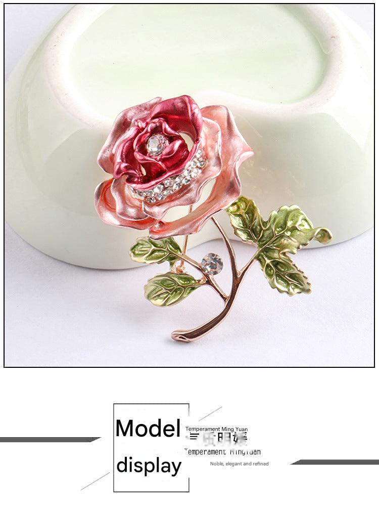 Vibrant red floral brooch on a white background