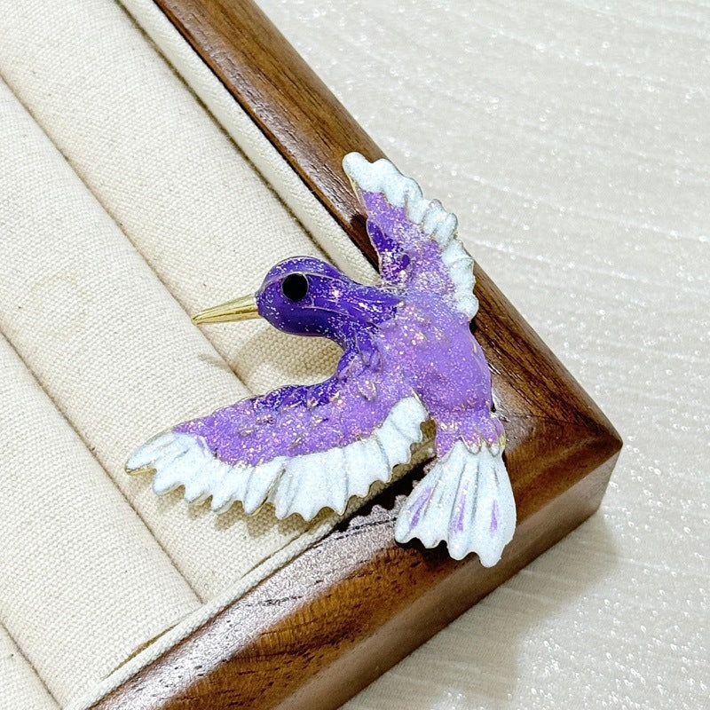 Side view of vintage blue wing bird enamel brooch
