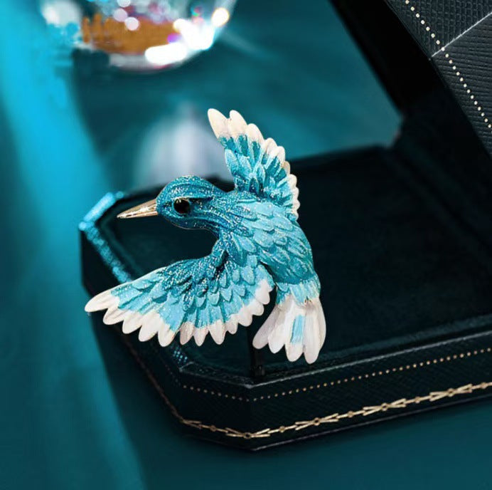 Side view of vintage blue wing bird enamel brooch
