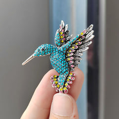 Hummingbird Brooch displayed on fabric background