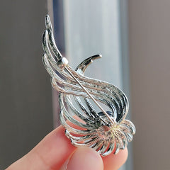 Unique women's accessory brooch displayed on fabric