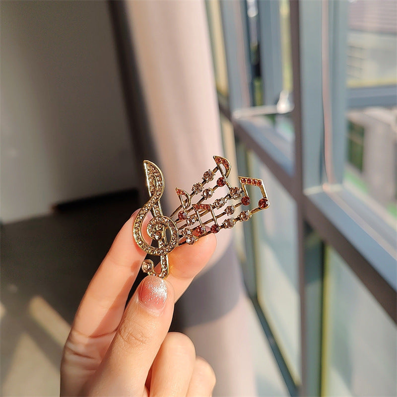 Elegant musical note brooch with rhinestones - image 1