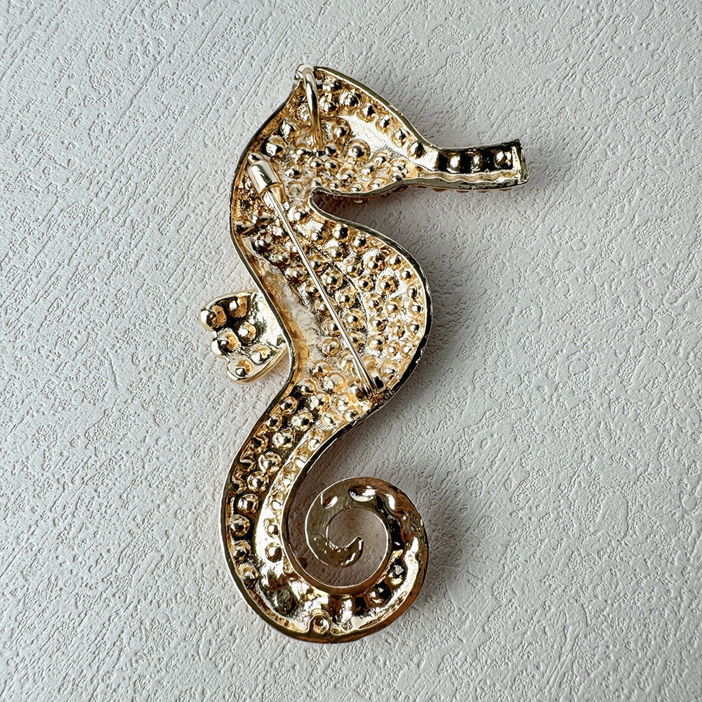 Close-up of stylish sea horse brooch