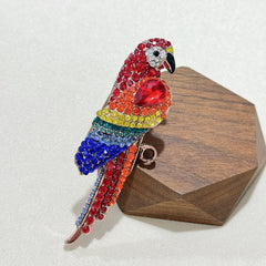 Elegant vintage parrot brooch on fabric
