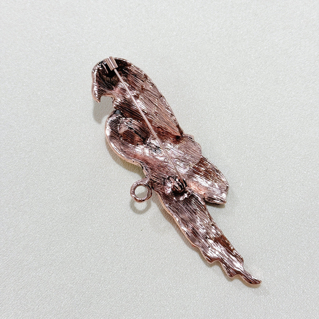 Close-up of the vibrant red parrot brooch