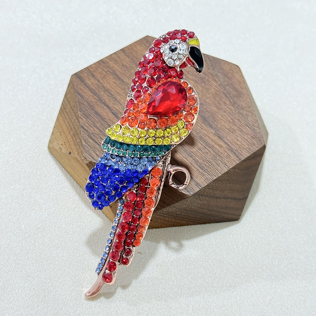 Close-up of the vibrant red parrot brooch