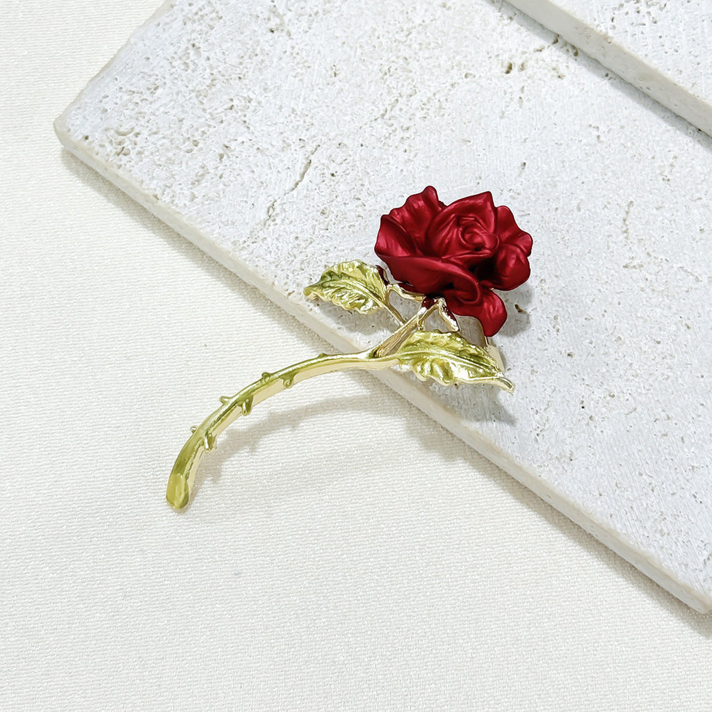 gift packaging with red rose brooch