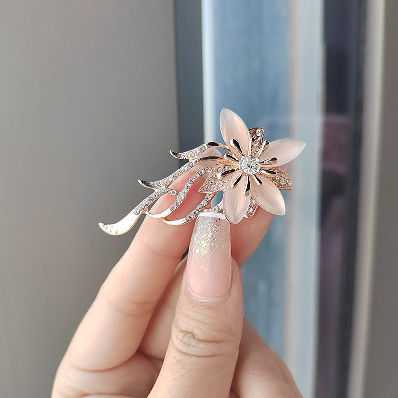 Close-up of blue gemstone floral brooch
