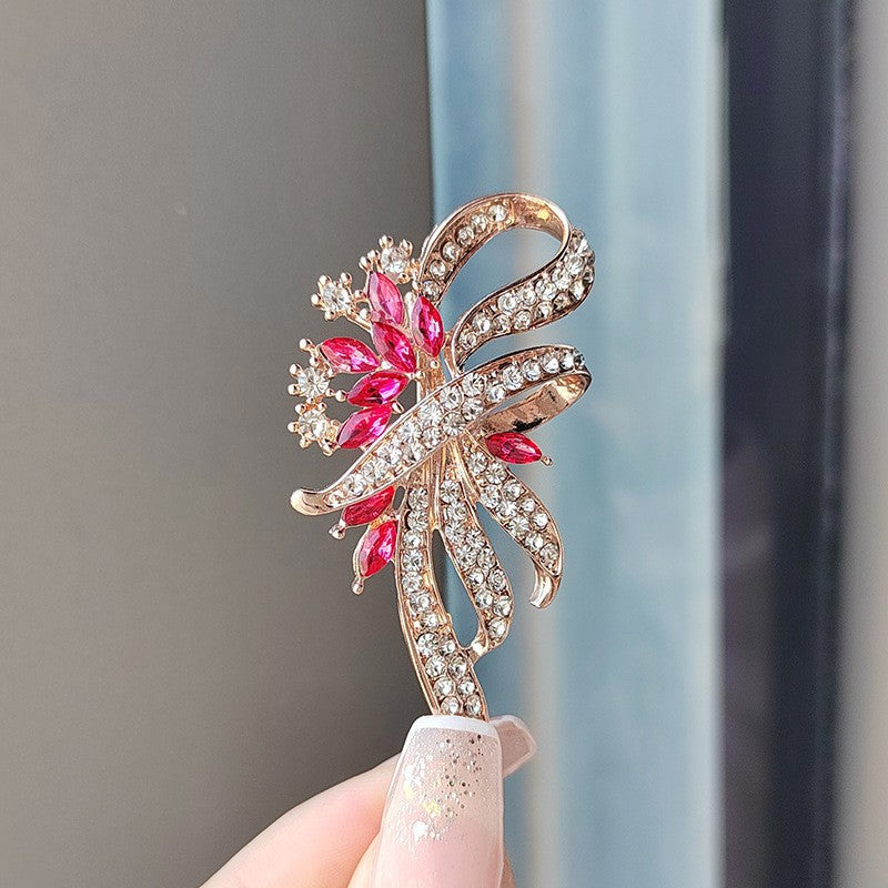 Floral brooch displayed on a neutral background