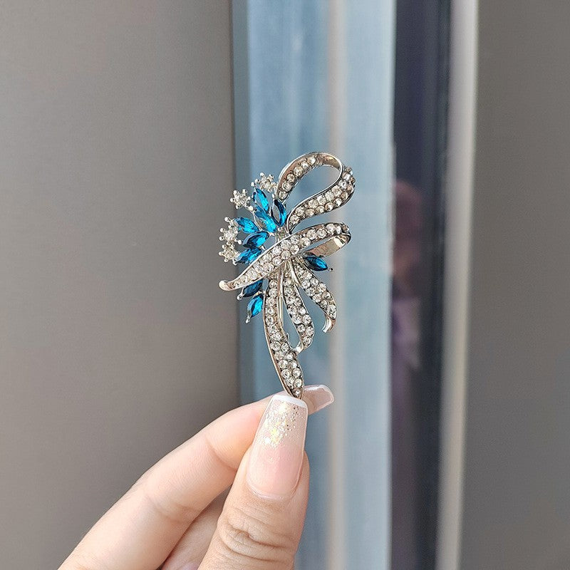 Vibrant blue floral brooch in elegant style