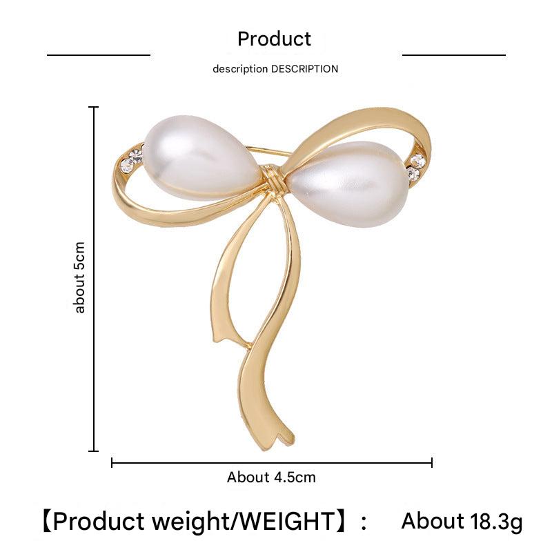 Golden Bow Brooch with Pearls showcased