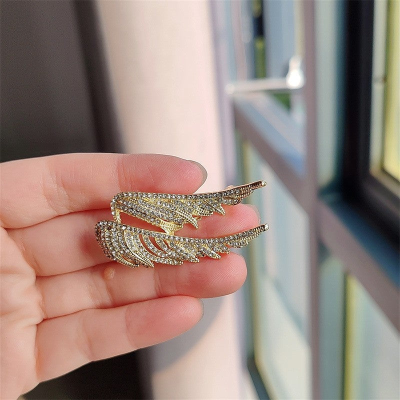 Intricate details of the angel wings brooch