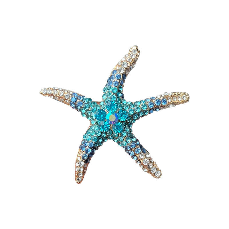 Green starfish brooch on a white background