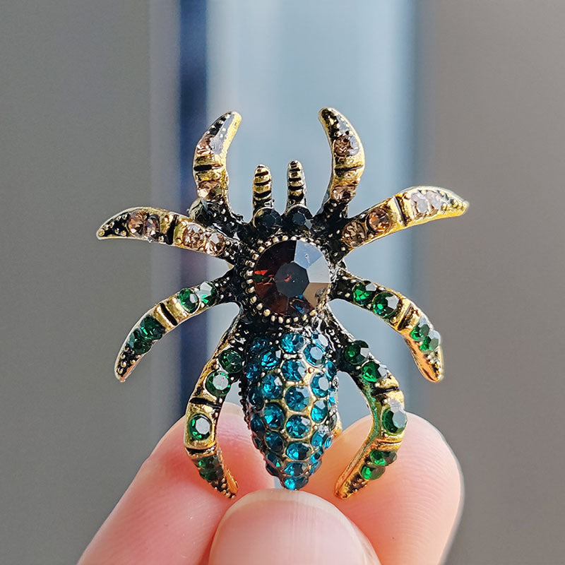 Stylish spider brooch on a blue background