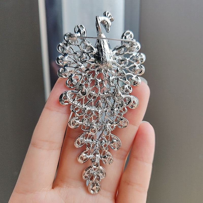 Stylish peacock brooch on a coat