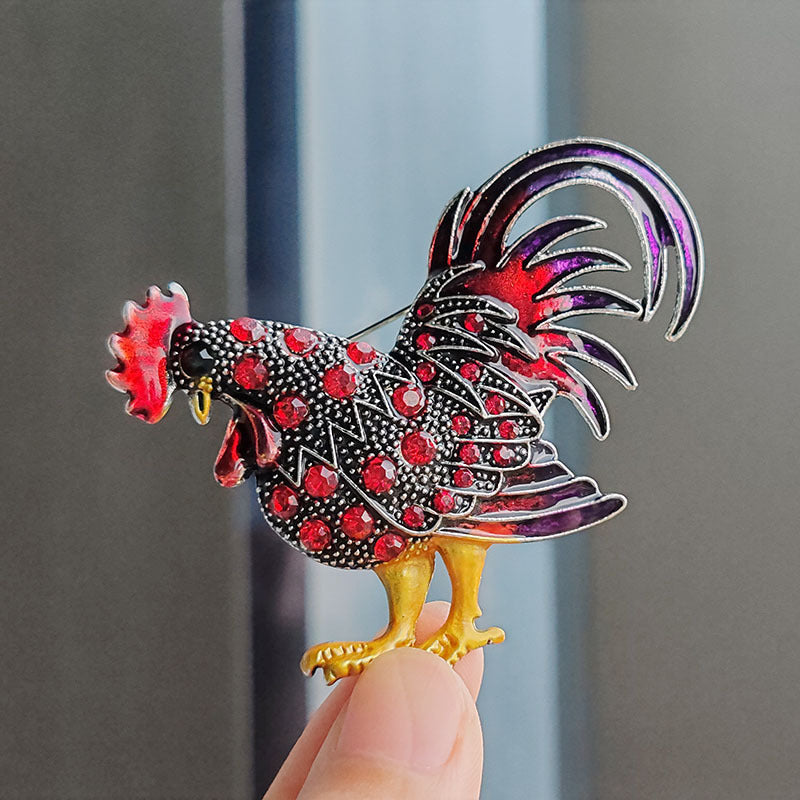 Close-up view of red vintage rooster brooch