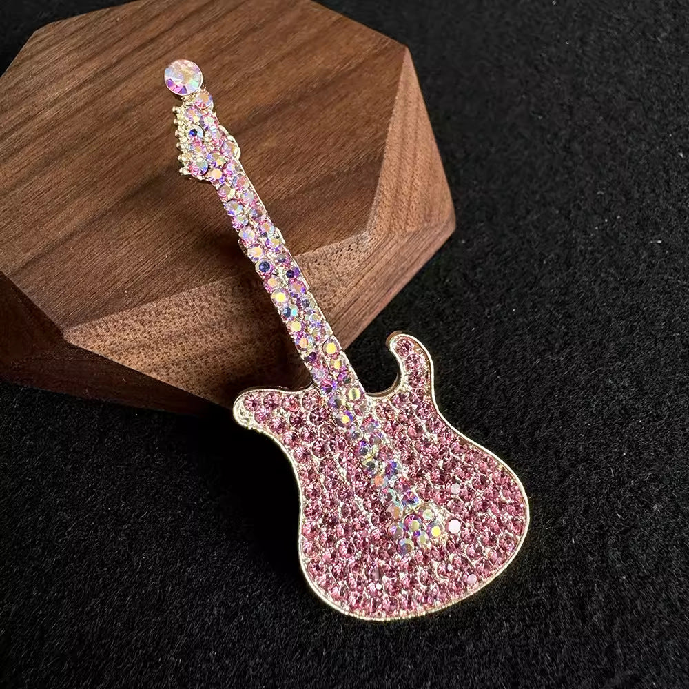 sparkling guitar-shaped brooch on a jacket
