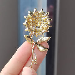 Close-up of sunflower brooch with crystals