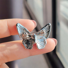 Versatile butterfly pin displayed on fabric