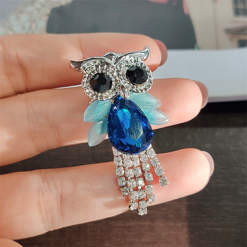Close-up of sparkling owl pin design