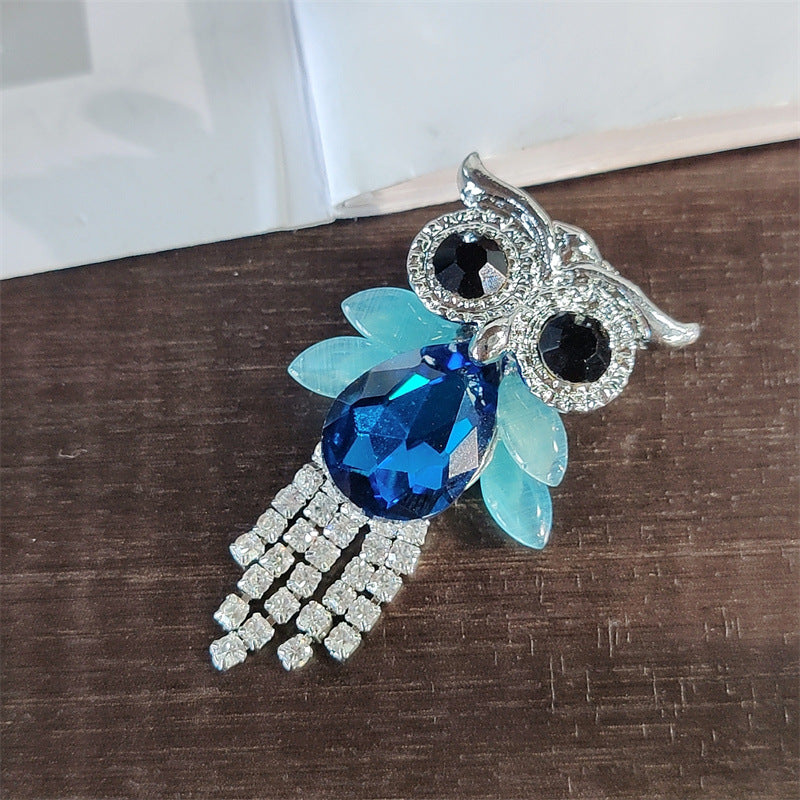 Vibrant owl brooch showcased in fashion setting