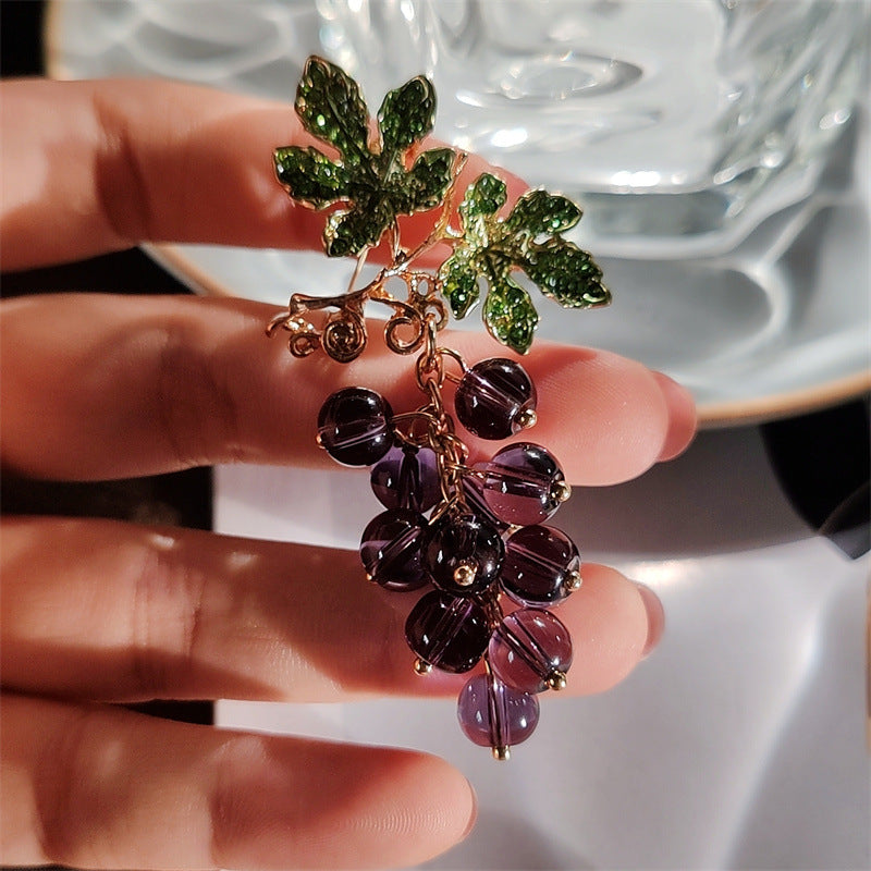 Elegant pin brooch with fruit design on model