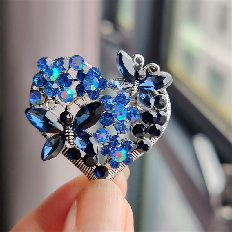 Elegant Butterfly Heart Brooch on display