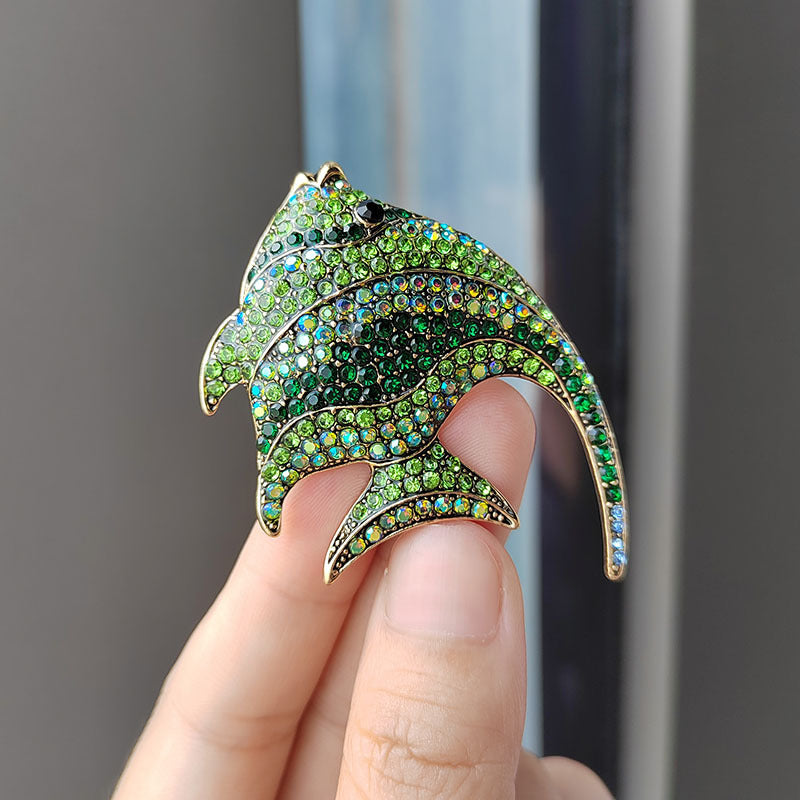 fun tropical fish brooch displayed on a table
