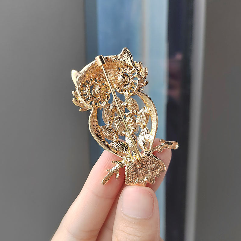 Owl brooch displayed on a simple background