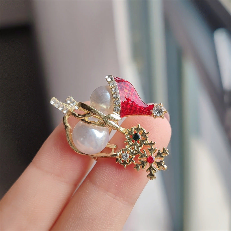 Snowman brooch displayed on sweater
