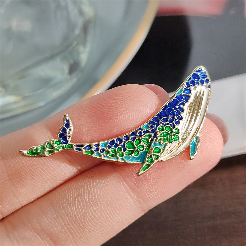 Vintage artistic brooch design featuring a whale