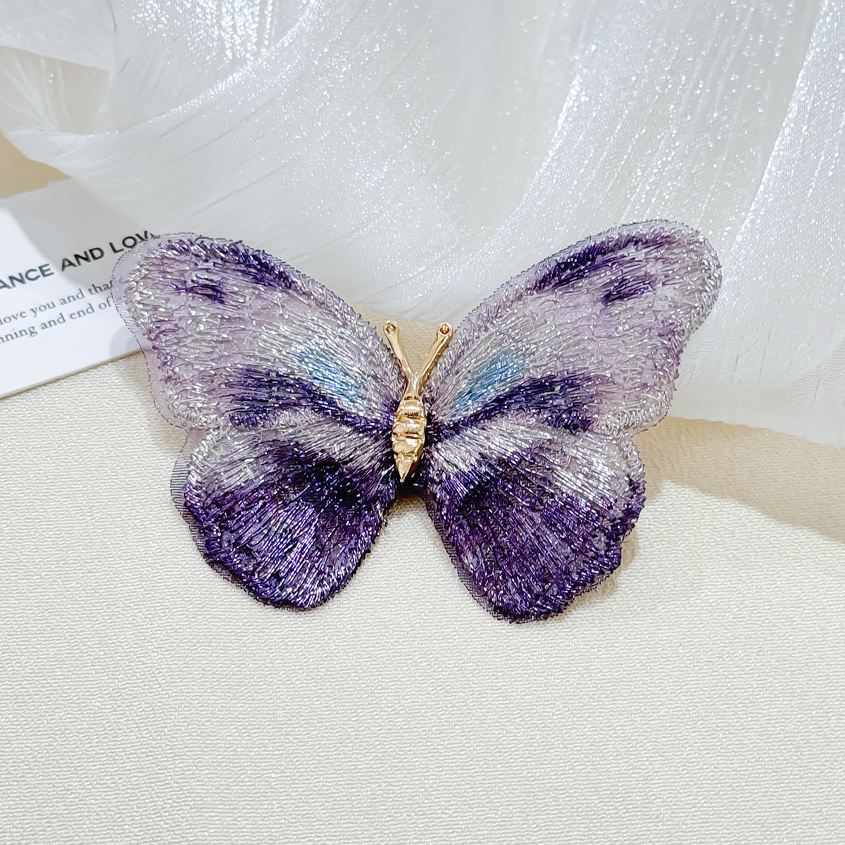 Close-up of floral brooch with butterfly design