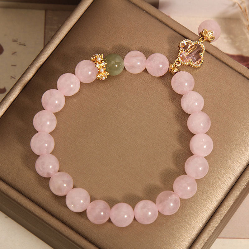 Pink quartz bracelet on display with its pendant