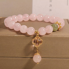 Four leaf clover pendant on pink quartz bracelet